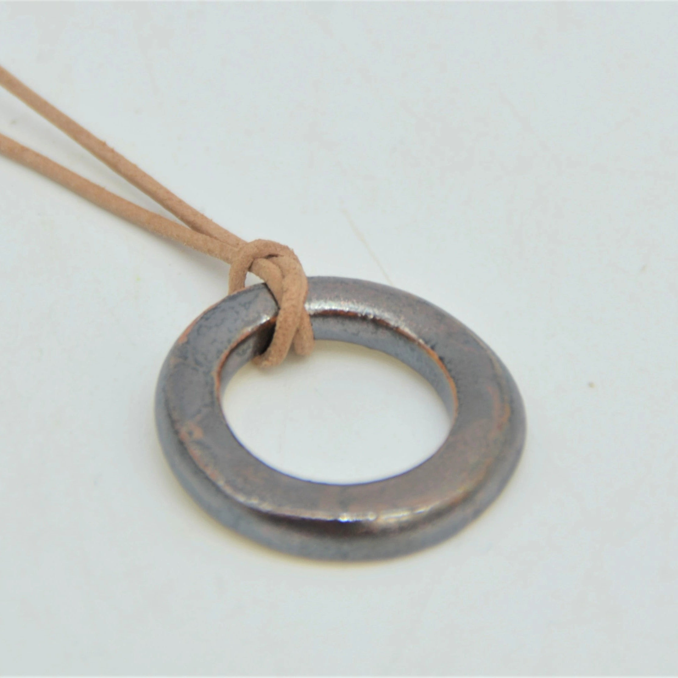 Colgante circular de cerámica artesanal marrón dorado con cordón de cuero y cierre de plata de ley, Maia Cerámica