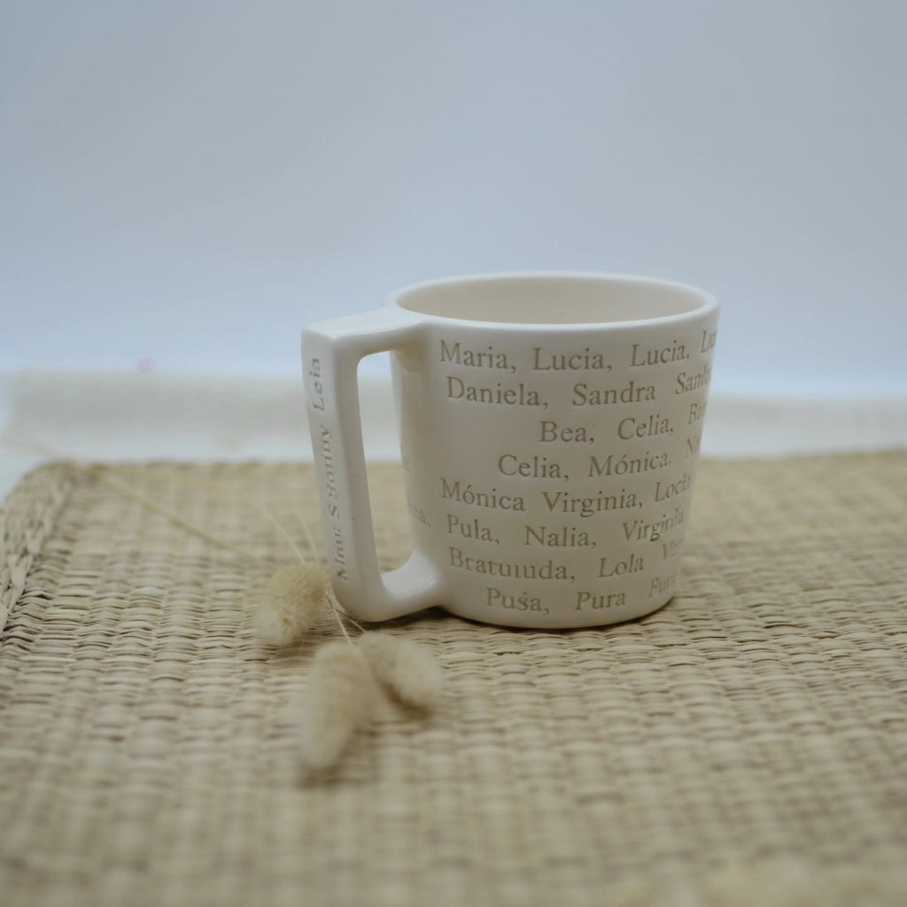 Detalle del texto personalizado en taza de cerámica artesanal Maia — letras pintadas a mano en relieve. blanco